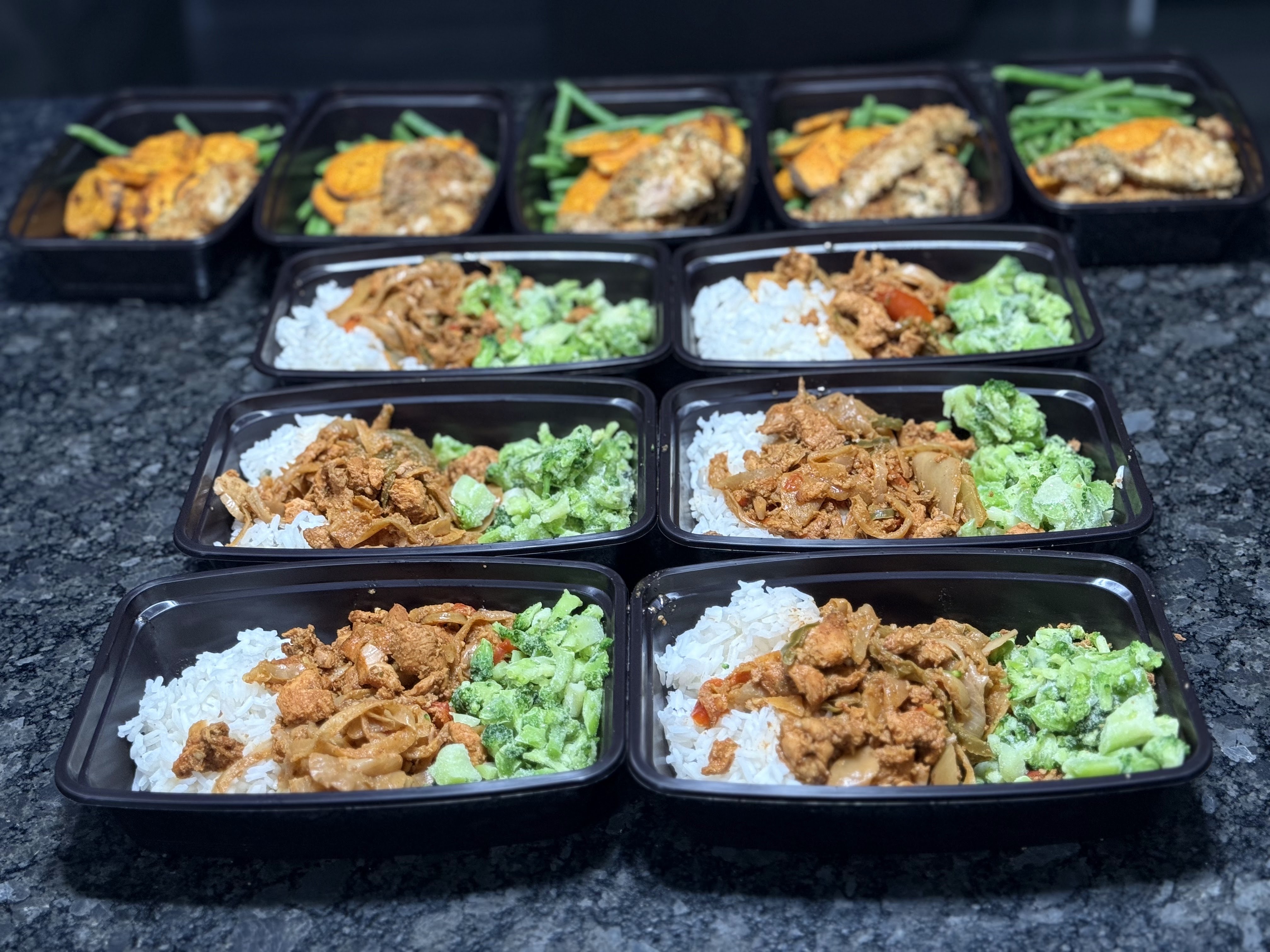 Multiple chicken, rice, and broccoli meal prep containers