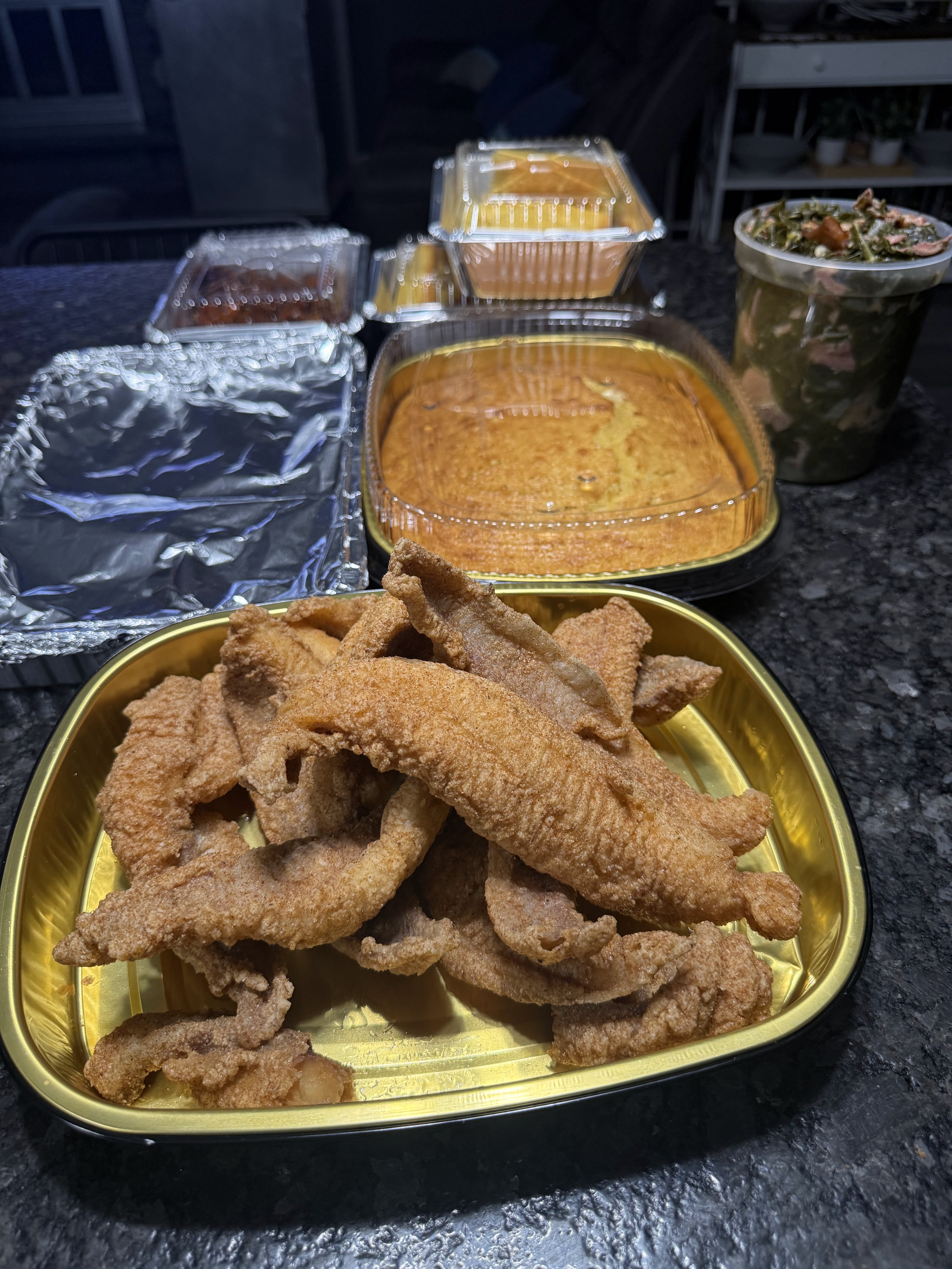 Fried fish with cornbread, greens, and catering sides