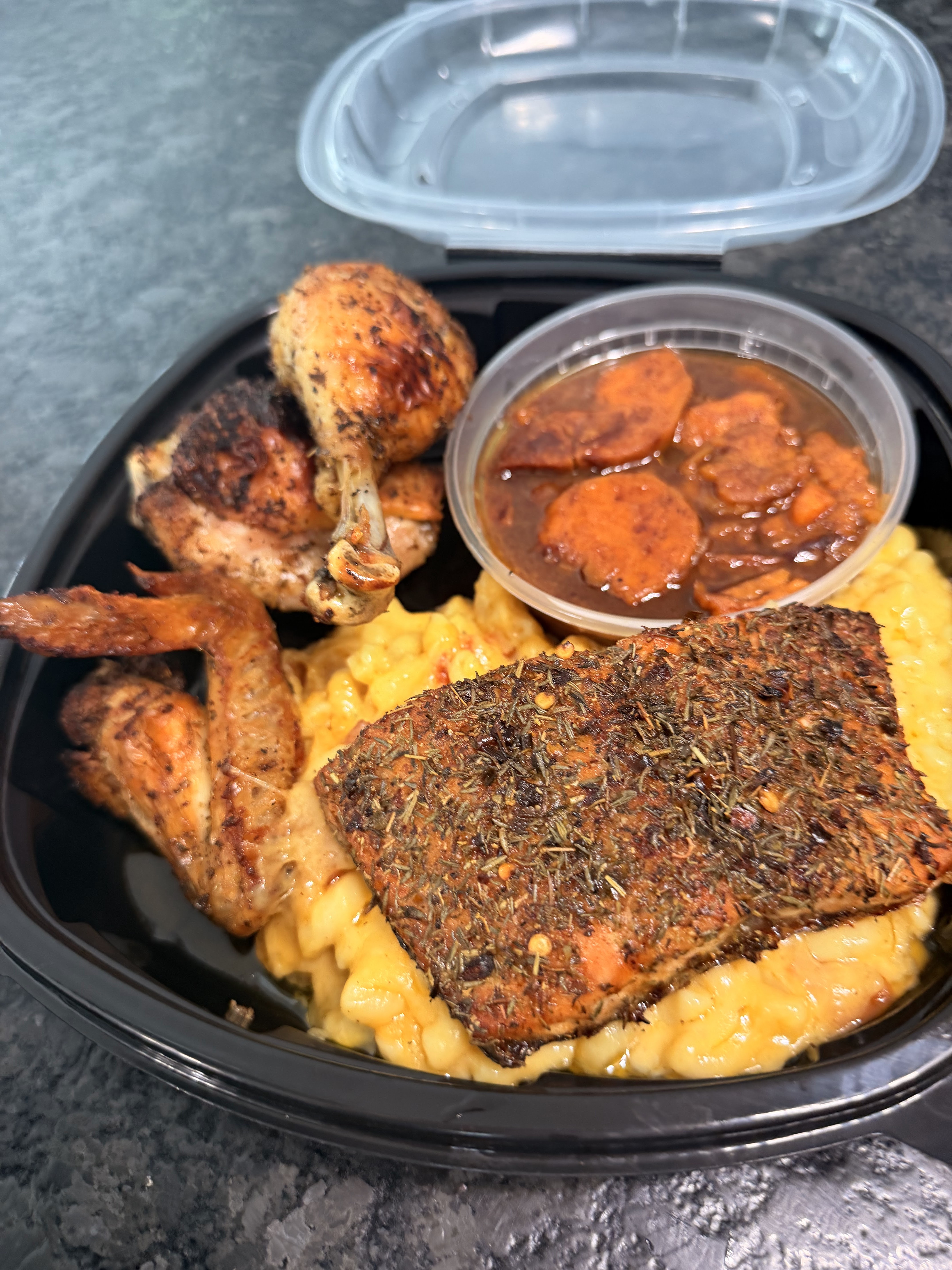 Seasoned salmon, chicken, macaroni, and candied sweet potatoes