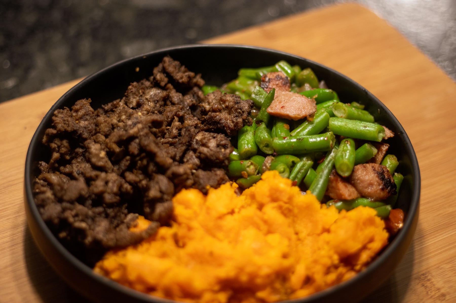 Clean Vibez meal prep bowl with seasoned protein, green beans, and mashed sweet potato